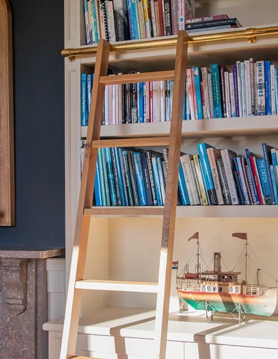 Fitted bookcase with ladder on rail